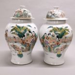 A pair of mid 20th century Chinese hand painted porcelain jars and lids, H. 39cm.