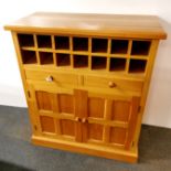 A modern light oak drinks cabinet with fitted wine rack, 110 x 97 x 48cm.