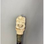 A walking stick with erotic carved bone handle, handle H. 7cm, cane L. 92cm.