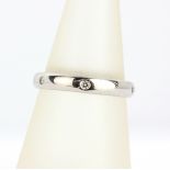 A 9ct white gold wedding band set with diamonds, (L.5).