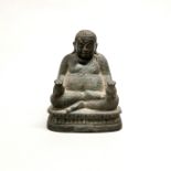 A 19th century Burmese bronze figure of a seated Buddha, H. 15cm.