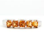 A 9ct white gold citrine set half eternity ring, (N).