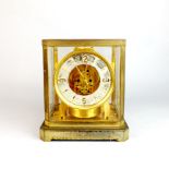 An interesting glass cased and brass Le Coultre Atmos clock, 23.5 x 19.5 x 15cm.