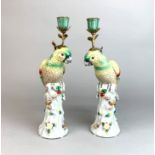 A pair of 20th century porcelain and gilt brass bird candlesticks, H. 37cm.
