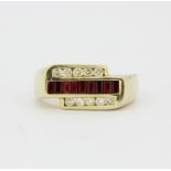 A heavy 14ct yellow gold (stamped 14K) ring set with baguette cut rubies and diamonds, (U).