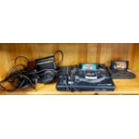 A vintage Sega Megadrive games console and related items.