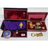 Two red leather cases of Masonic medals and other items including silver gilt.