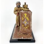 A 1920's/30's Vienna style cold painted metal strike lighter of an Arab carpet seller, H. 14.5cm.