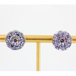 A large pair of silver stud earrings set with tanzanites, approx. 4.01ct total, L. 1.6cm. With