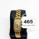 A gents vintage 9ct gold JW Benson wrist watch on a gold plated strap.