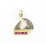 A yellow metal yacht shaped pendant set with baguette cut rubies and diamonds, L. 2cm.