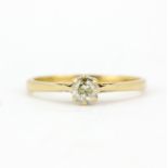 A hallmarked 18ct yellow gold diamond set solitaire ring, (O).