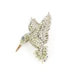 A yellow and white metal hummingbird brooch set with green tourmalines, diamonds and a sapphire