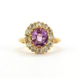 A yellow metal (tested high carat gold, approx. 22ct) cluster ring set with a large oval cut pink