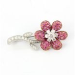 A stunning 18ct white gold (stamped 18K) flower shaped brooch set with round cut rubies and