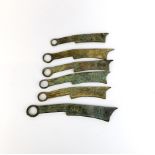 A group of six Chinese sword shaped coins, longest 6.5cm.