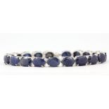 A 925 silver bracelet set with oval cut sapphires, approx. 49.74ct total, L. 19cm. With
