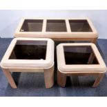 An interesting design plate glass and light wood coffee table together with two matching side tables