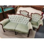 A three piece suite comprising of a two seater button backed settee and two button backed armchairs,