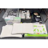 A quantity of Wii consoles, games and accessories, including Wii fit boards.