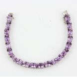 A hallmarked silver bracelet set with oval cut Rose de France amethyst, approx. 34.11ct total, L.