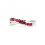 A 9ct white gold ring set with rubies, (N).
