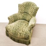 A green leopard print upholstered armchair with tassel border, H. 83cm.