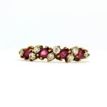 A 9ct yellow gold ring set with marquise cut rubies and white stones, (M.5).
