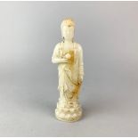 A Chinese glass, imitating jade, figure of a standing Buddha, H. 20cm.