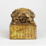A Chinese carved stone seal decorated with liondogs, 10.5 x 13cm.