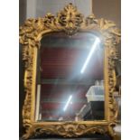 A large ornate gilt framed mirror, W. 118cm, H. 150cm.