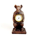 An interesting 20th century carved black forest bear shaped clock, H. 30cm, D. 10cm.