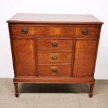 A spade foot mahogany cabinet with two blind doors and two doors, housing a record deck and tuner,