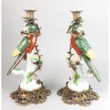 A pair of ormulu mounted porcelain parrot candlesticks, H. 35cm.