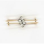A yellow metal (tested approx. 18ct gold) bar brooch set with old brilliant cut diamonds,