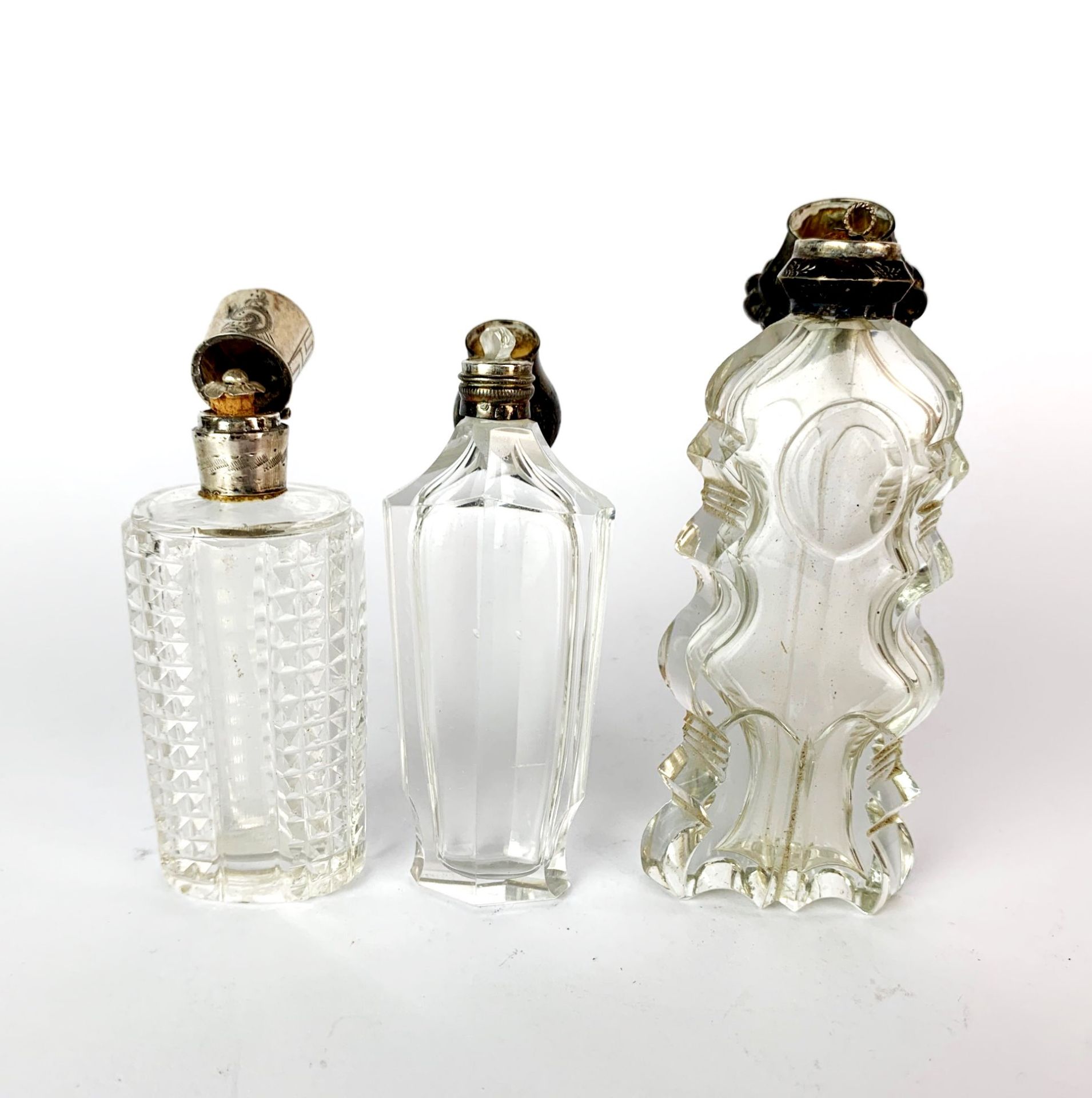 Three antique cut glass and silver topped (tested) perfume bottles, tallest H. 12cm. - Image 2 of 2