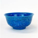 A Chinese blue glazed porcelain bowl, relief decorated with dragons, Dia. 15cm H. 7cm.