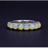 A 925 silver eternity ring set with round cabochon opals, approx. 2.97ct total, (N). With