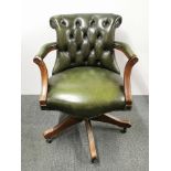 A button backed, leather upholstered desk chair on castors, H. 86cm.