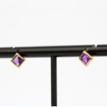 A pair of 9ct yellow gold and amethyst stud earrings, L. 5mm.