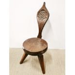 A signed 'Jack Grimble' of Cromer circular oak, three legged spinning chair decorated with a tudor