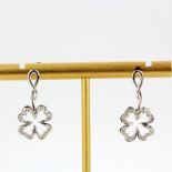 A pair of 9ct white gold shamrock shaped drop earrings set with diamonds, L. 2cm.