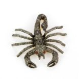 An impressive large yellow metal and diamond scorpion brooch with ruby set eyes, L. 6cm.