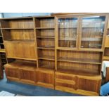 A teak three piece wall unit/ bookcase with drop-down desk/ drinks station and fitted six bottle