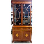 An impressive inlaid mahogany bookcase over cabinet, W. 100cm, H. 215cm.