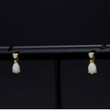 A pair of 9ct yellow gold opal set drop earrings, L. 8mm.