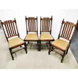 A set of four 20th Century carved oak and barley twist dining chairs.