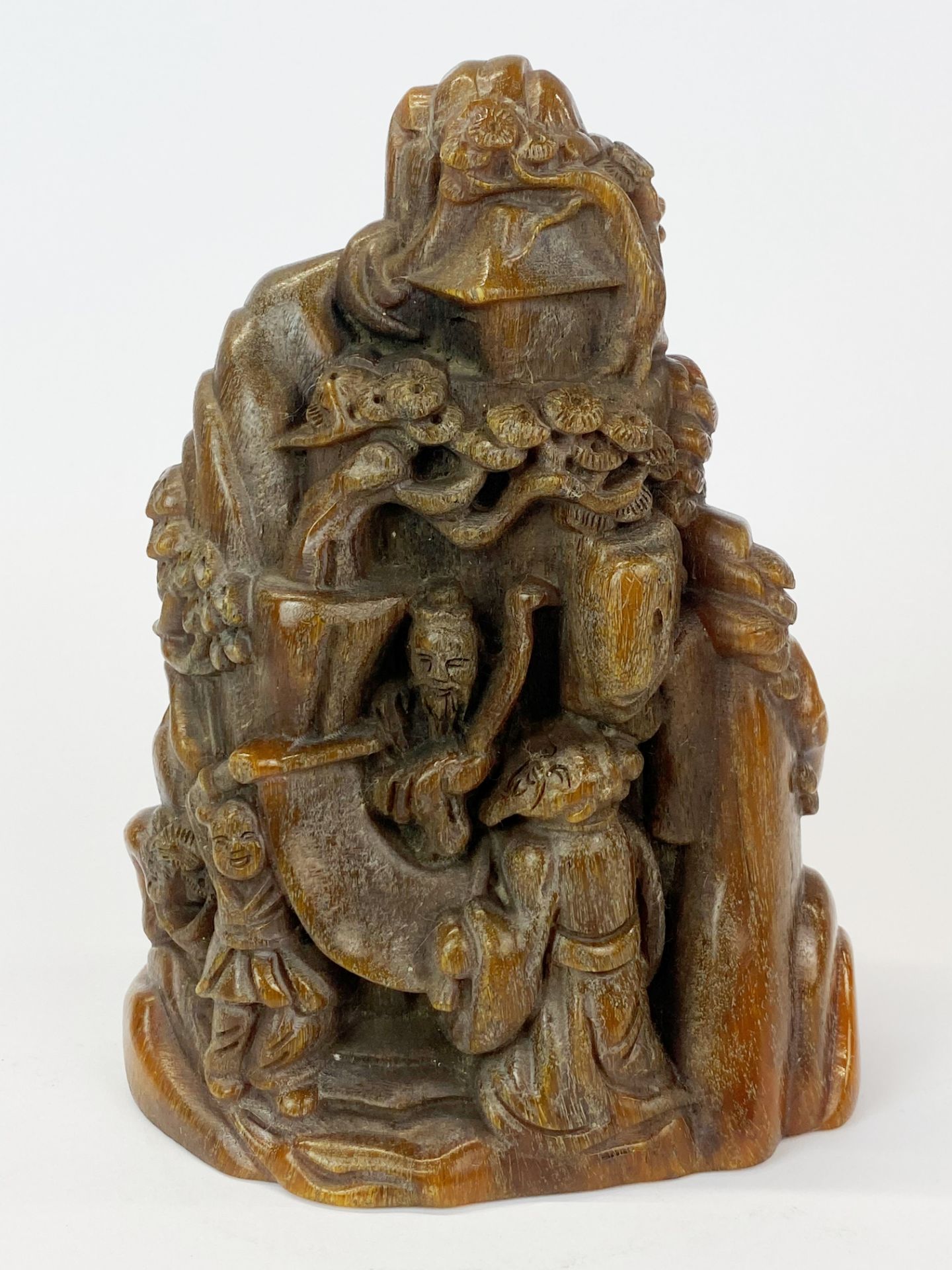 A Chinese carved faux rhino horn model of sages in mountain scenery, H. 17cm.