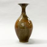 A Chinese Ming Dynasty style incised and olive green glazed porcelain vase, H. 27cm.