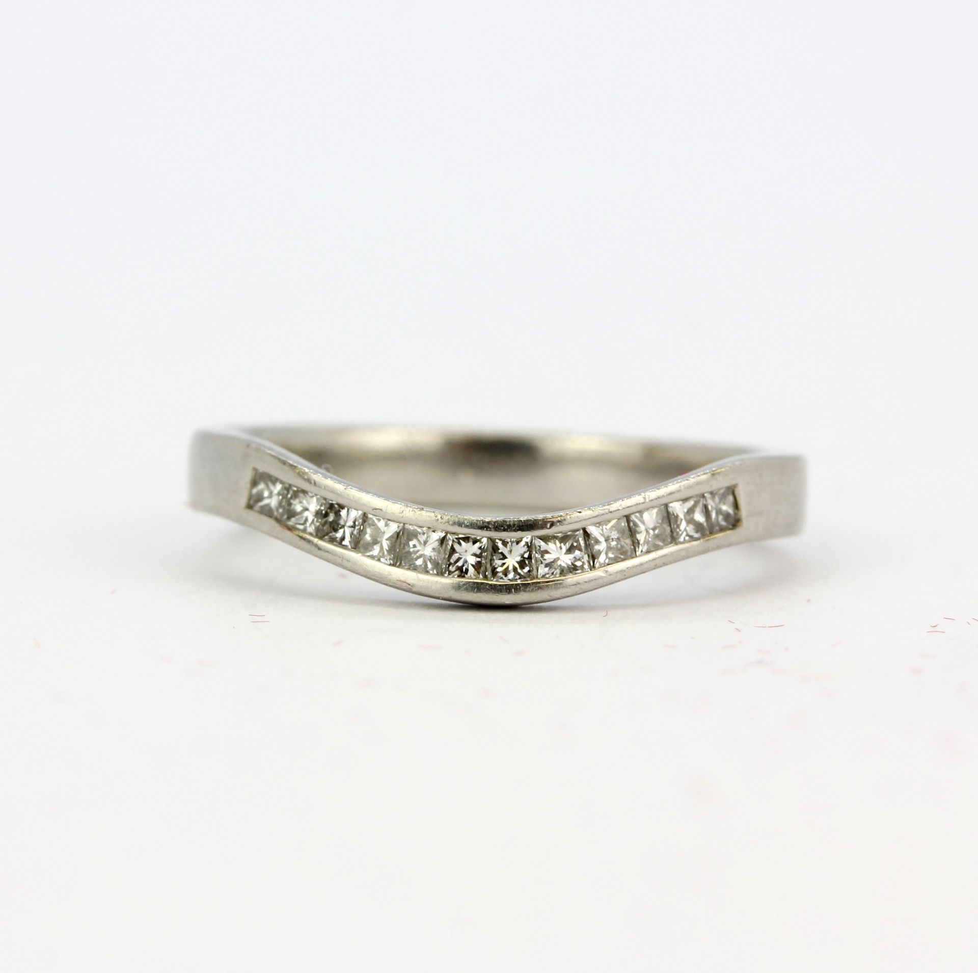 A platinum (stamped) ring set with diamonds, (J).